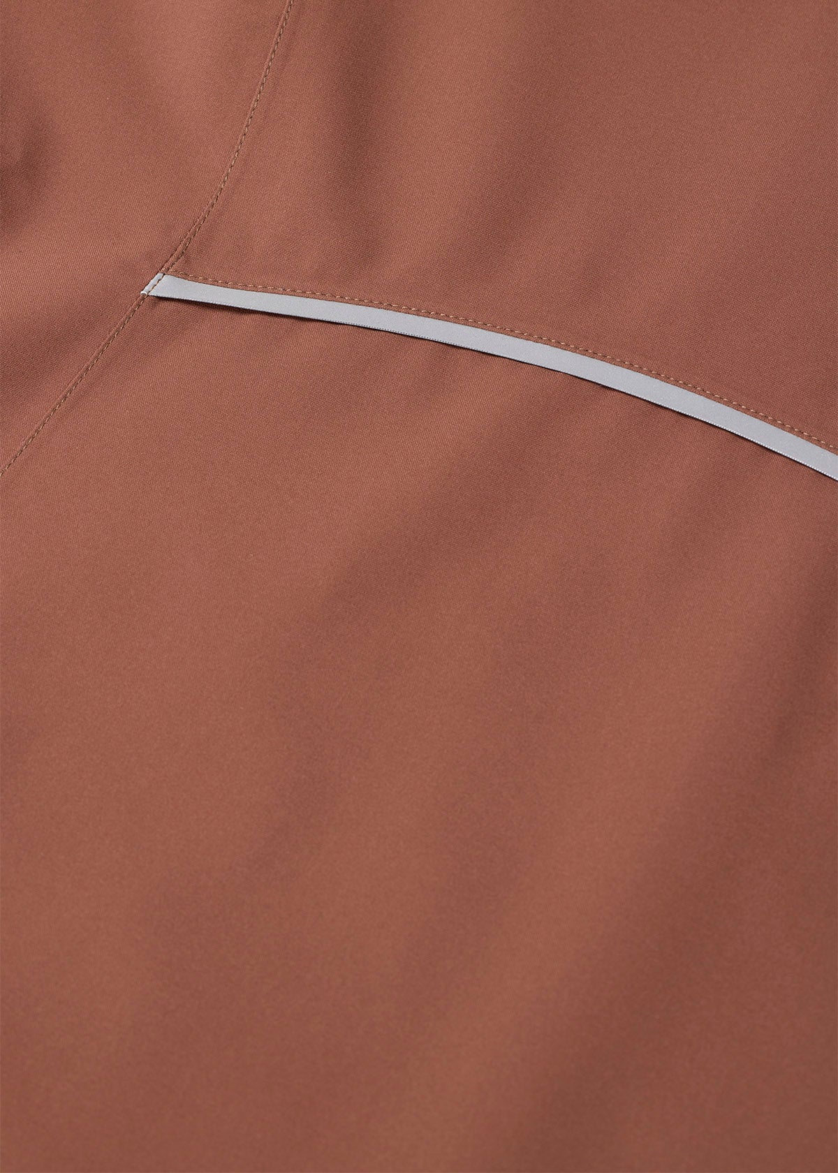 Close-up of reflective stripe detail on brown waterproof jacket
