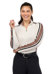 Woman wearing a light beige long sleeve riding shirt standing and smiling