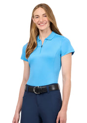 Woman wearing a bright blue short sleeve polo shirt with riding breeches, front view
