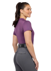 Side view of a female model wearing the purple Kerrits Serenity Coolcore Short Sleeve Polo on a white background