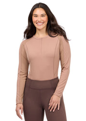 Woman wearing a tan long sleeve riding top, front view