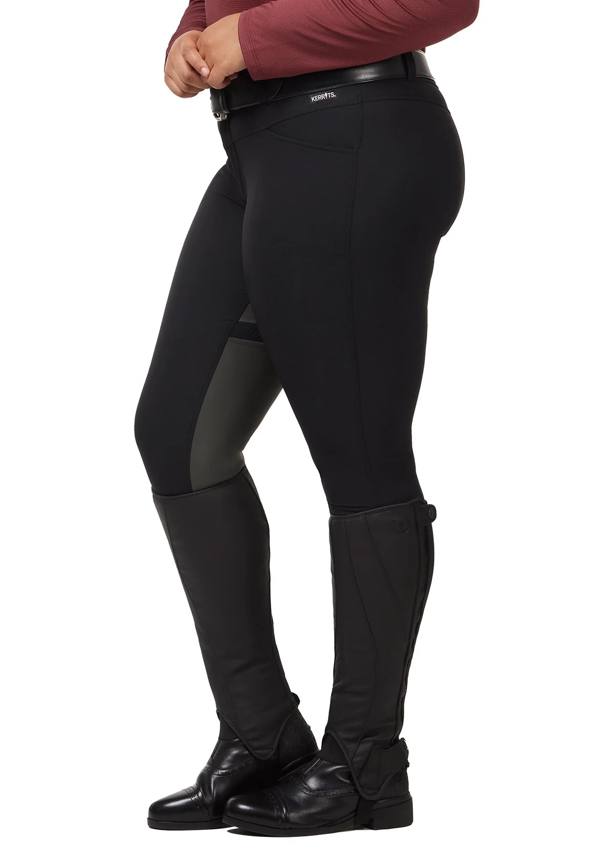 Side view of a model wearing the black Kerrits Crossover II Full Seat Breech on a white background