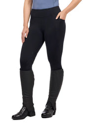 Woman wearing black riding tights with tall boots, front view