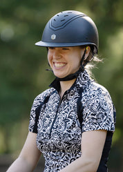 Close-up of rider wearing a patterned shirt and helmet