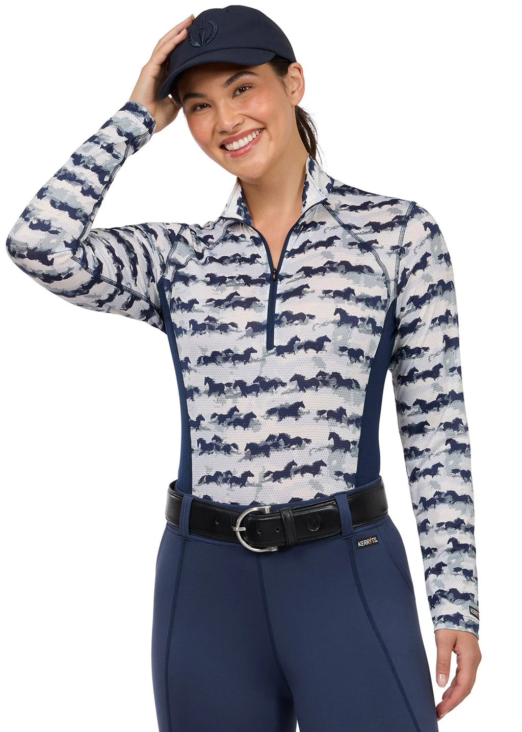 Woman wearing a horse print long sleeve riding shirt, front view