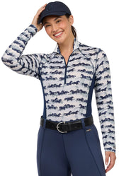 Woman wearing a horse print long sleeve riding shirt, front view