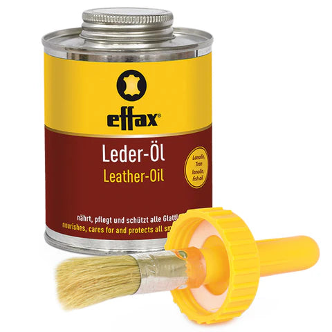 Front view of a can of Effax Leather Oil with the brush in front of it on a white background