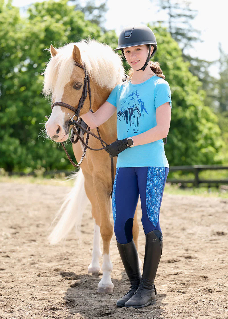Rider leading a horse while wearing navy tights with blue patterned panels