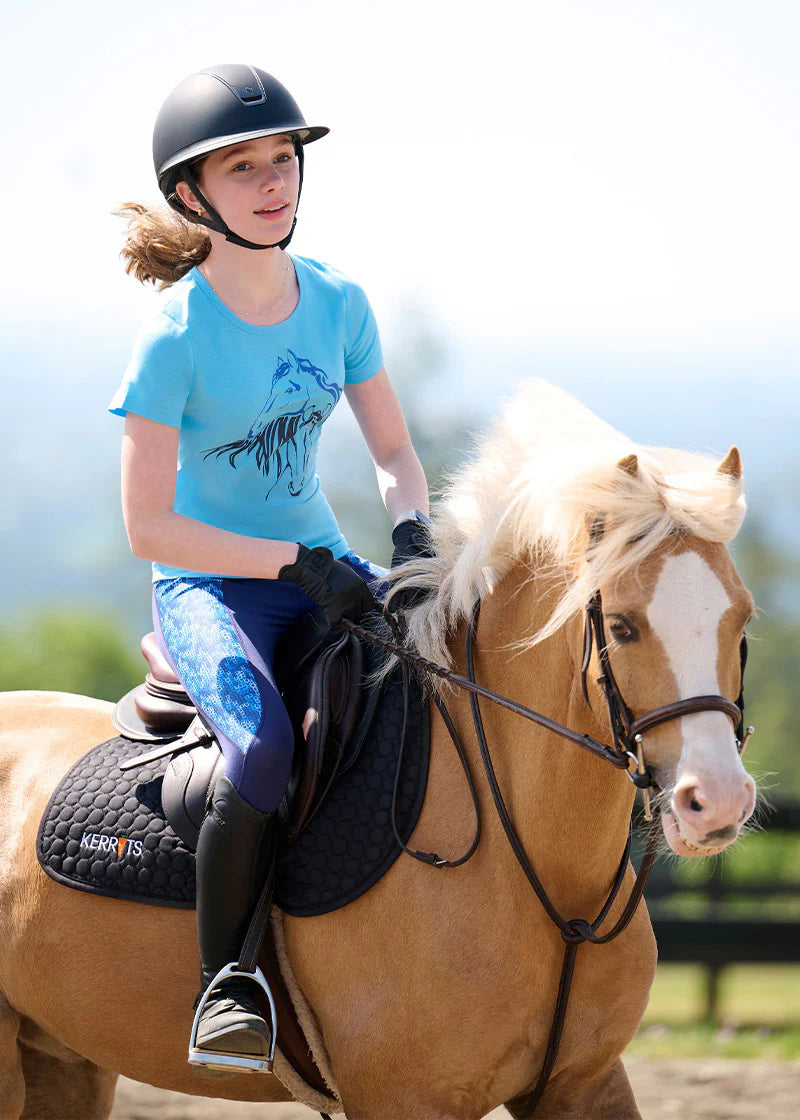 Young female model wearing the navy blue patterned tights while riding a palmonino pony