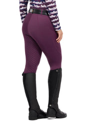 Side view of a female model wearing the purple Kerrits Coolcore Full Leg Tech Tight on a white background