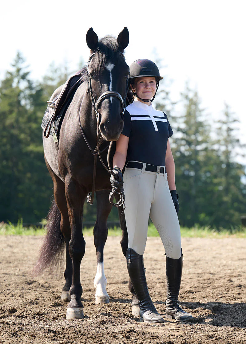 Woman standing with a horse wearing black short sleeve riding shirt with white stripe detail