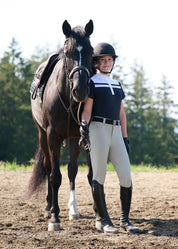 Woman standing with a horse wearing black short sleeve riding shirt with white stripe detail