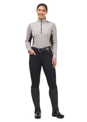 Full body front view of a model wearing the black Kerrits 3-Season Tailored Full Seat Breeches, patterned top, black half chaps, and black boots on a white background