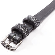 Close-up view of the decorated keepers on the black Kavalkade Victoria Spur Straps on a white background