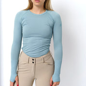 Front view of a female model wearing the Malibu TKEQ Kennedy Seamless Long Sleeve Shirt 2.0 on a white background