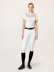 Full body front view of a female model wearing the white Equestrian Stockholm Crystal Champion Competition Top with white breeches on a white background