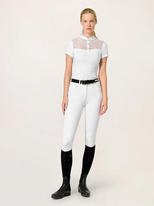 Full body front view of a female model wearing the white Equestrian Stockholm Crystal Champion Competition Top with white breeches on a white background