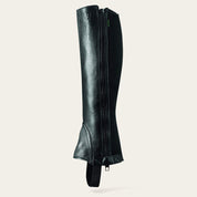Side view of the black Ariat Breeze Half Chap on a plain background