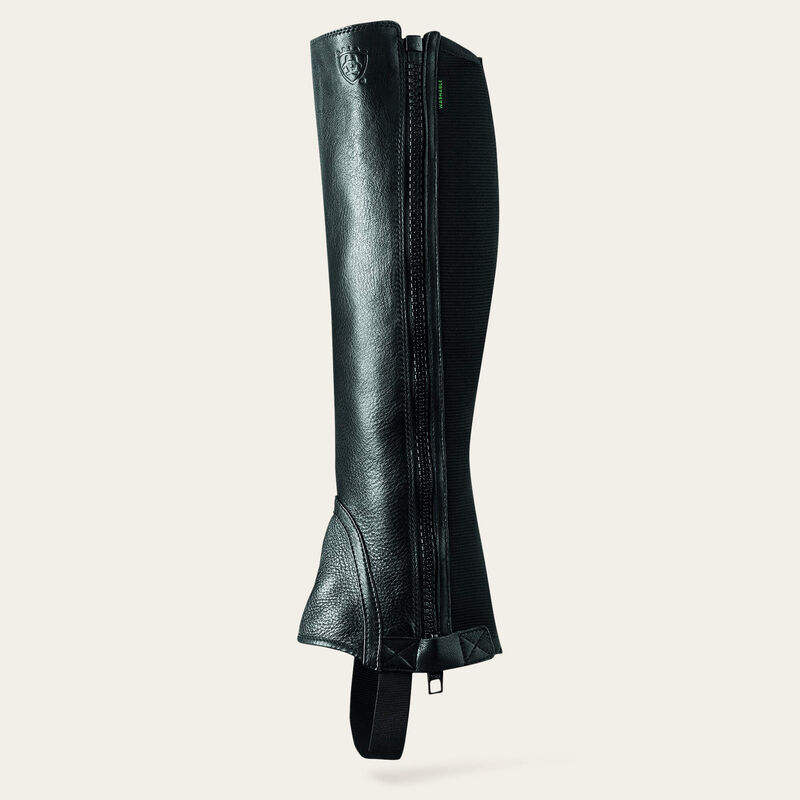 Side view of the black Ariat Breeze Half Chap on a plain background