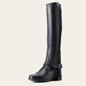 Angled side view of the black Ariat Breeze Half Chaps over a paddock boot on a plain background