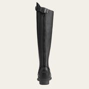 Back view of the Ariat Close Contour Half Chaps over a paddock boot on a plain background