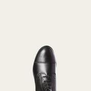 Close-up view of the toe cap of the black Ariat Heritage Contour II Field Zip Tall Riding Boot on a gray background