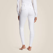 Back view of a model wearing the white Ariat Tri Factor Grip Full Seat Breech on a plain background