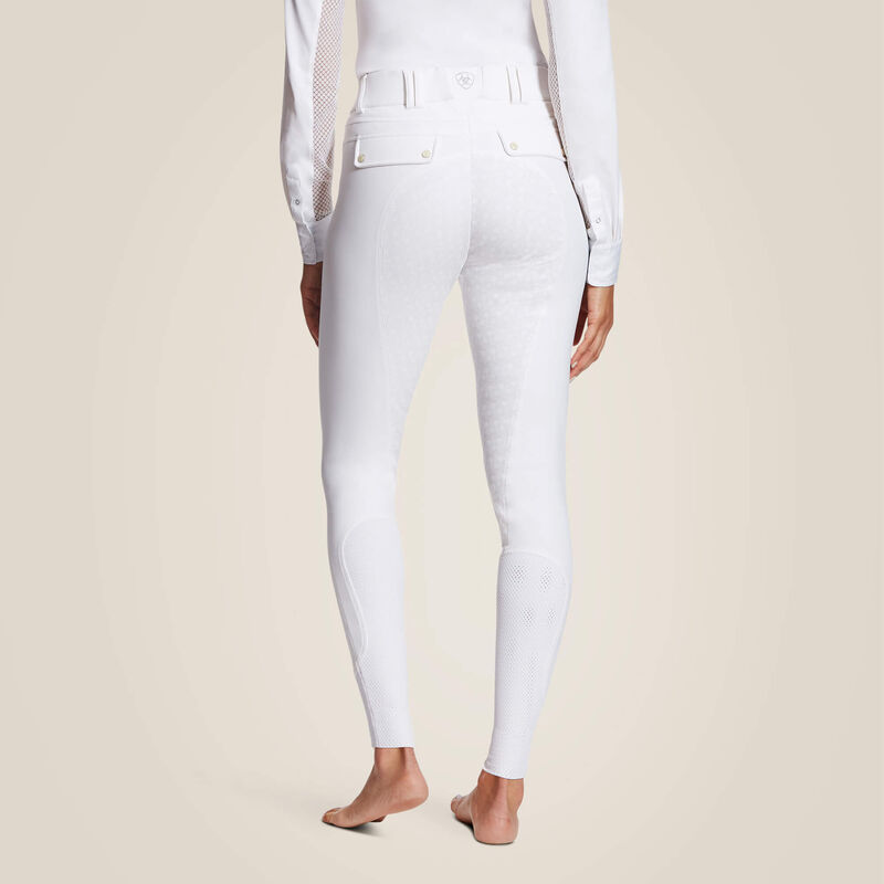 Back view of a model wearing the white Ariat Tri Factor Grip Full Seat Breech on a plain background