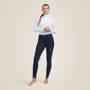 Full body front view of a female model wearing the navy Ariat Tri Factor Grip Knee Patch Breech on a plain background
