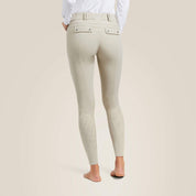 Back view of a model wearing the tan Ariat Tri Factor Grip Knee Patch Breech on a plain background