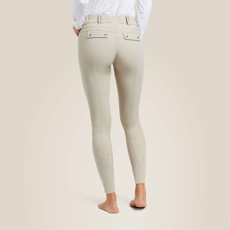 Back view of a model wearing the tan Ariat Tri Factor Grip Knee Patch Breech on a plain background