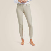 Front view of a model wearing the tan Ariat Tri Factor Grip Knee Patch Breechon a plain background