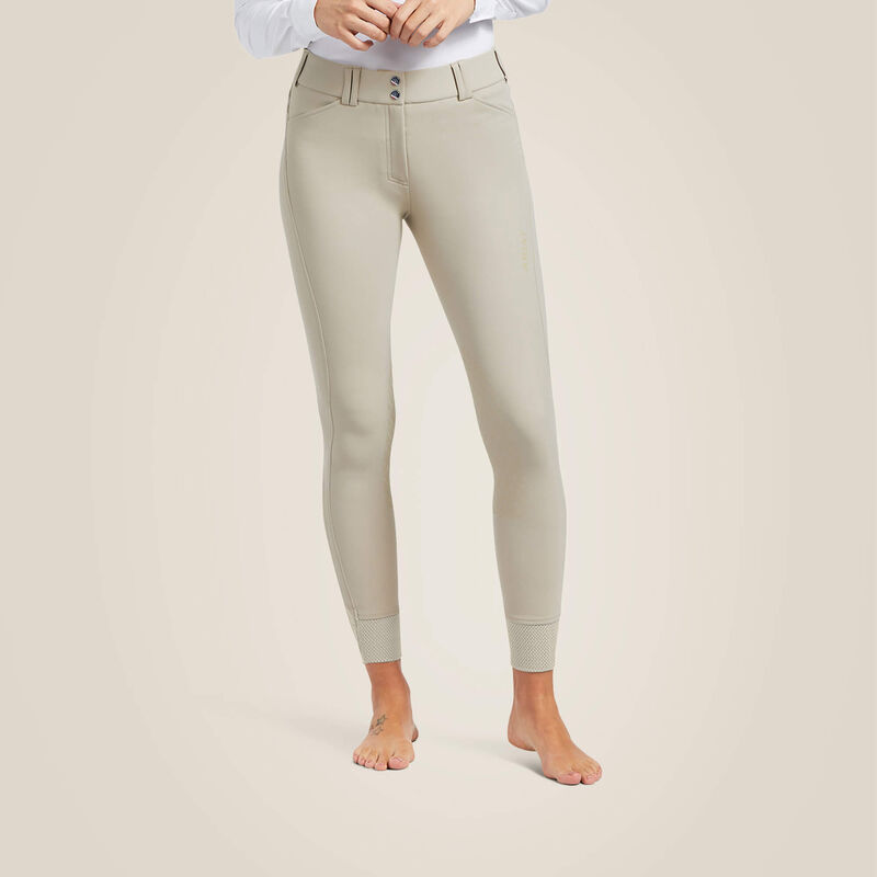 Front view of a model wearing the tan Ariat Tri Factor Grip Knee Patch Breechon a plain background