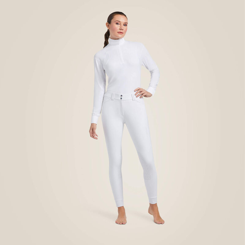 Full body front view of a female model wearing the white Ariat Tri Factor Grip Knee Patch Breech on a plain background
