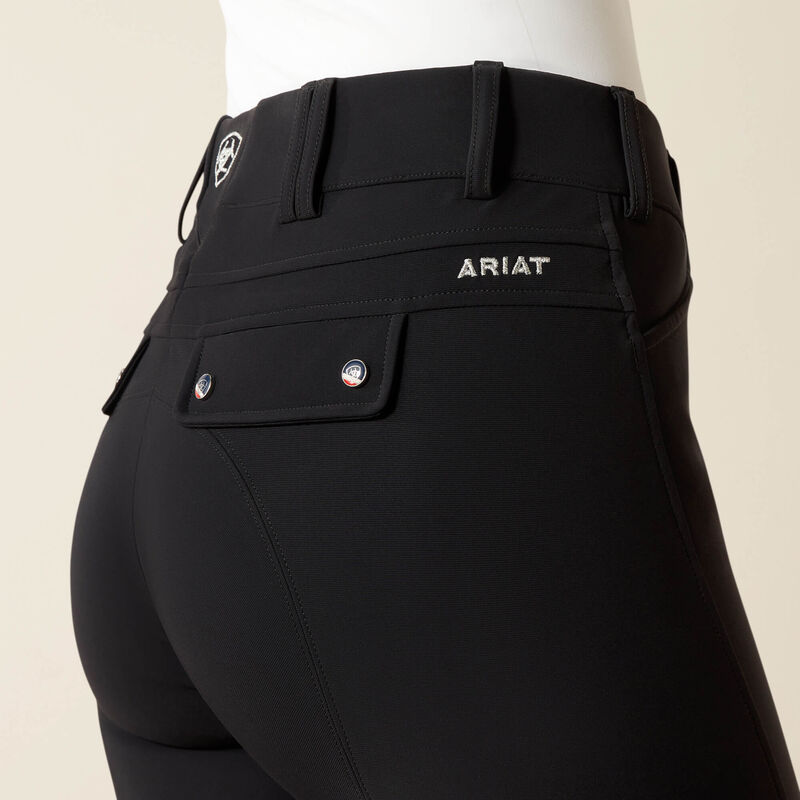 Close-up back view of a model wearing the black Ariat Tri Factor Grip Knee Patch Breech on a plain background