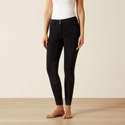 Front view of a model wearing the black Ariat Tri Factor Grip Knee Patch Breech in a studio setting