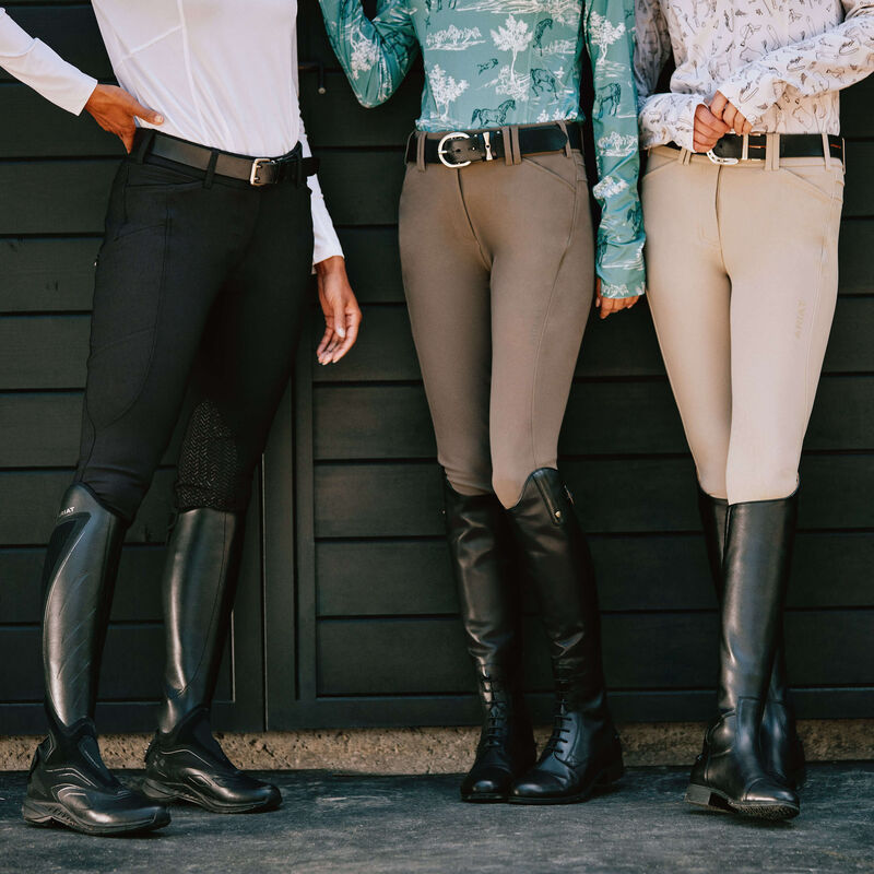 View of three models wearing Ariat Tall Boots including the Ariat Kinsley Dress Tall Boot while standing in a barn