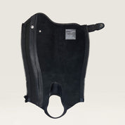 Interior view of the black Ariat Heritage Contour Half Chap over a paddock boot