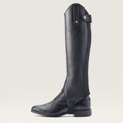 Side view of the black Ariat Heritage Contour Half Chap over a paddock boot