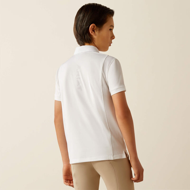 Back view of a young model wearing the Ariat Youth Tek Short Sleeve Show Shirt in white with tan breeches in a studio setting