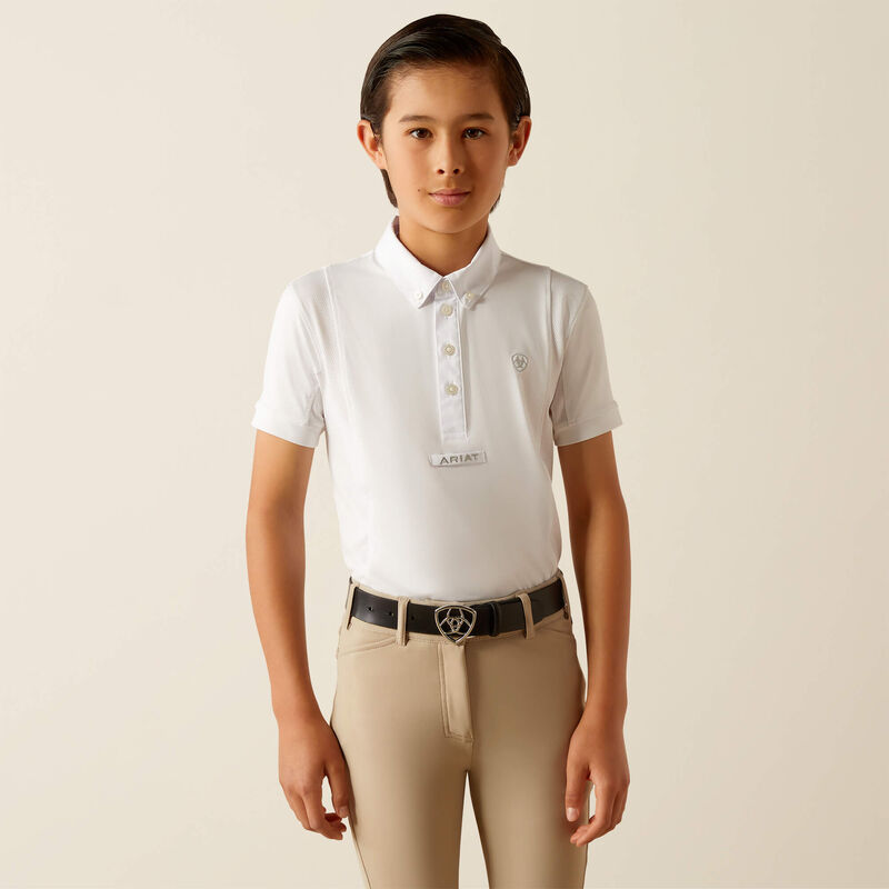 Front view of a young model wearing the Ariat Youth Tek Short Sleeve Show Shirt in white with tan breeches in a studio setting