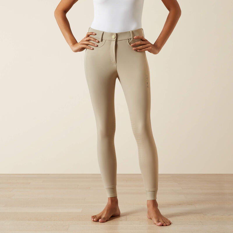 Front view of a model wearing the tan Ariat Tri Factor NT Knee Patch Breech in a studio setting