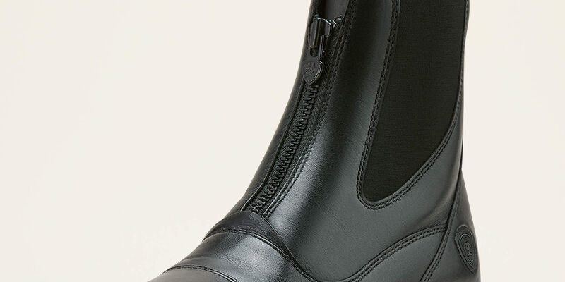 Angled front view of the black Ariat Heritage Zip Paddock Boot on a plain background