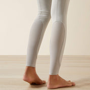 Close-up back view of the lower legs of a model wearing the Ariat Tri Factor NT Full Seat Breech in gray in a studio setting