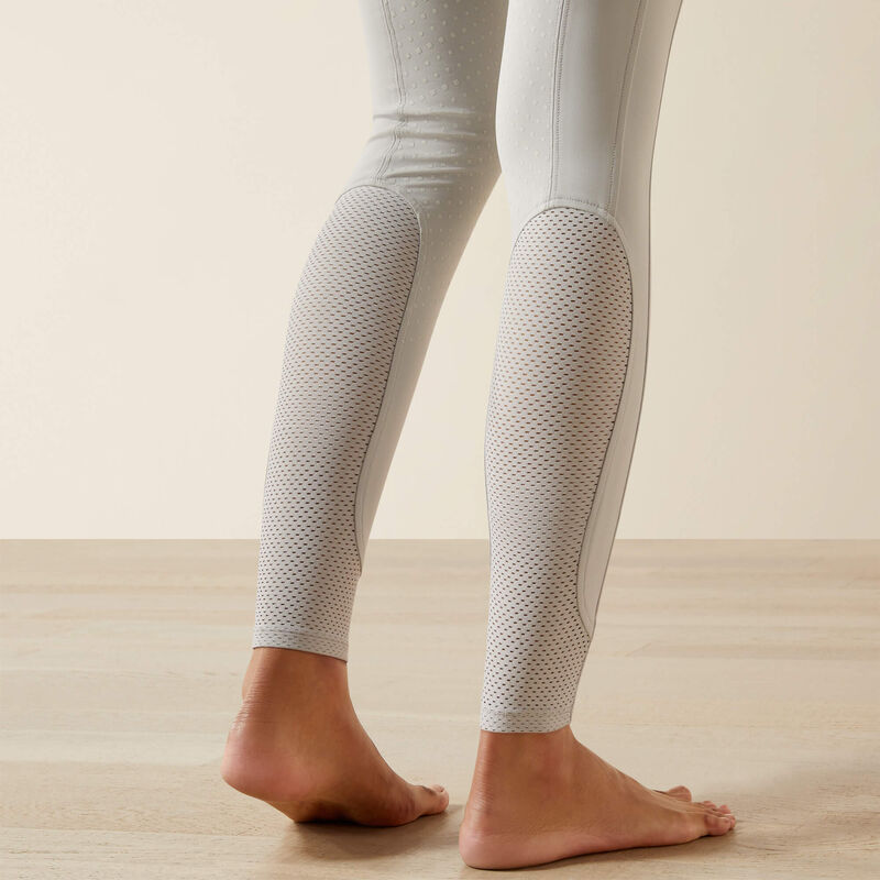 Close-up back view of the lower legs of a model wearing the Ariat Tri Factor NT Full Seat Breech in gray in a studio setting
