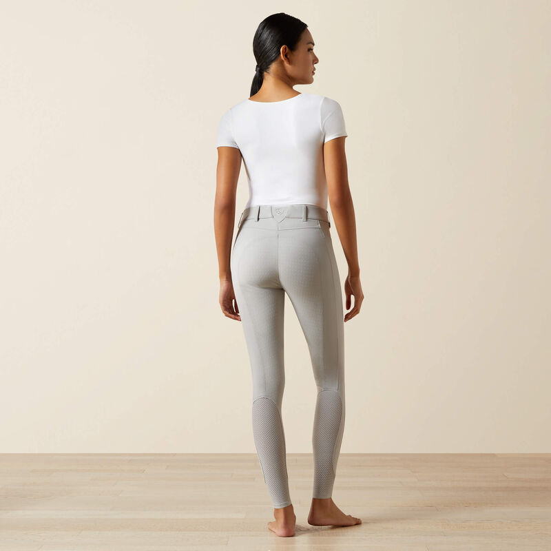 Full body back view of a model wearing the gray Ariat Tri Factor NT Full Seat Breech and a white shirt in a studio setting