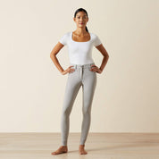 Full body front view of a model wearing the gray Ariat Tri Factor NT Full Seat Breech and a white shirt in a studio setting