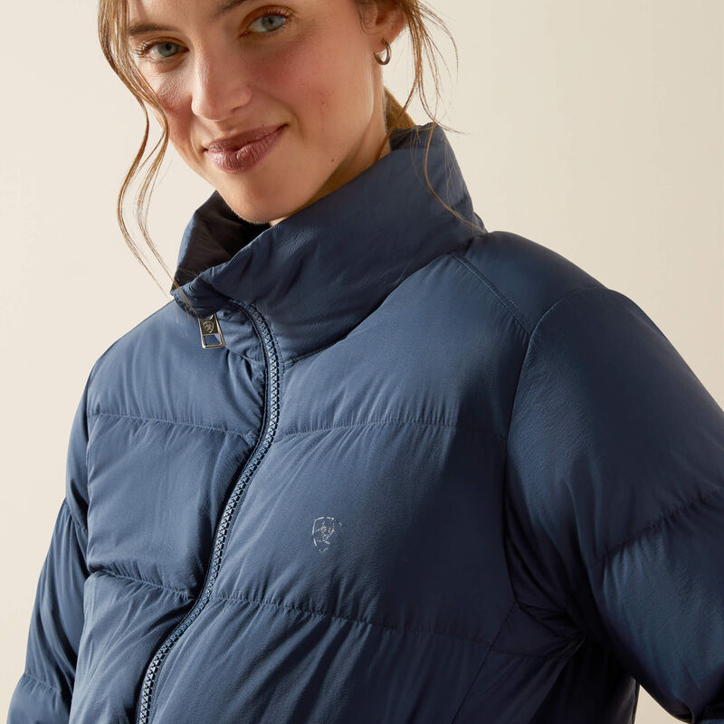 Close-up angled front view of a female model wearing the Big Dipper Ariat Ultrapuff Down Jacket on a plain background