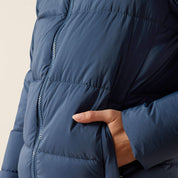 Close-up side view of a female model wearing the Big Dipper Ariat Ultrapuff Down Jacket on a plain background