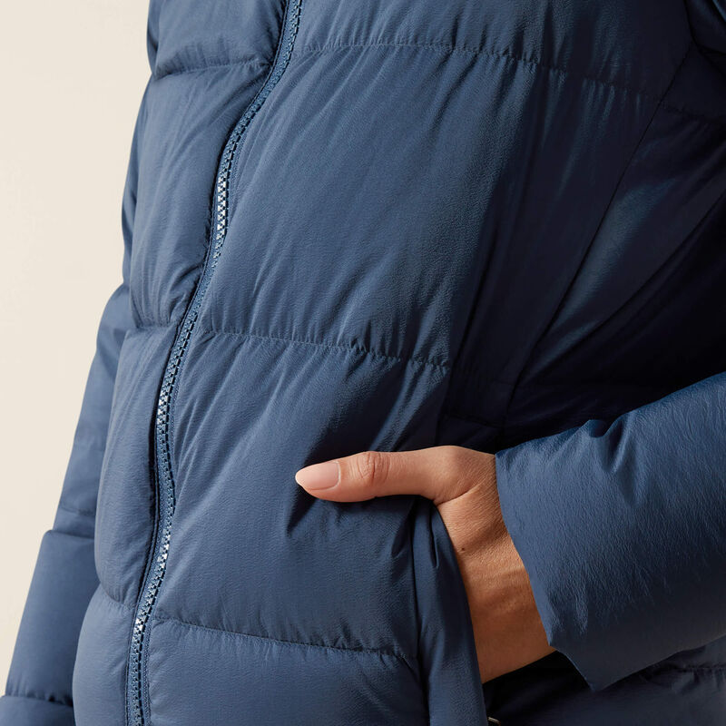 Close-up side view of a female model wearing the Big Dipper Ariat Ultrapuff Down Jacket on a plain background